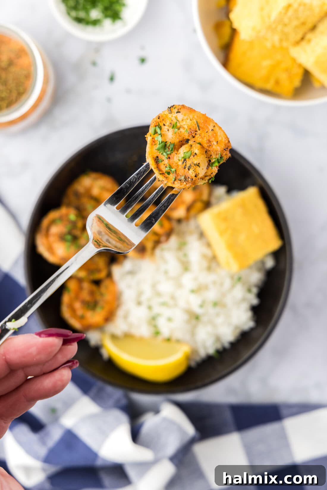 Cajun Shrimp on a fork, showcasing its vibrant color and tender texture, ready to be enjoyed.