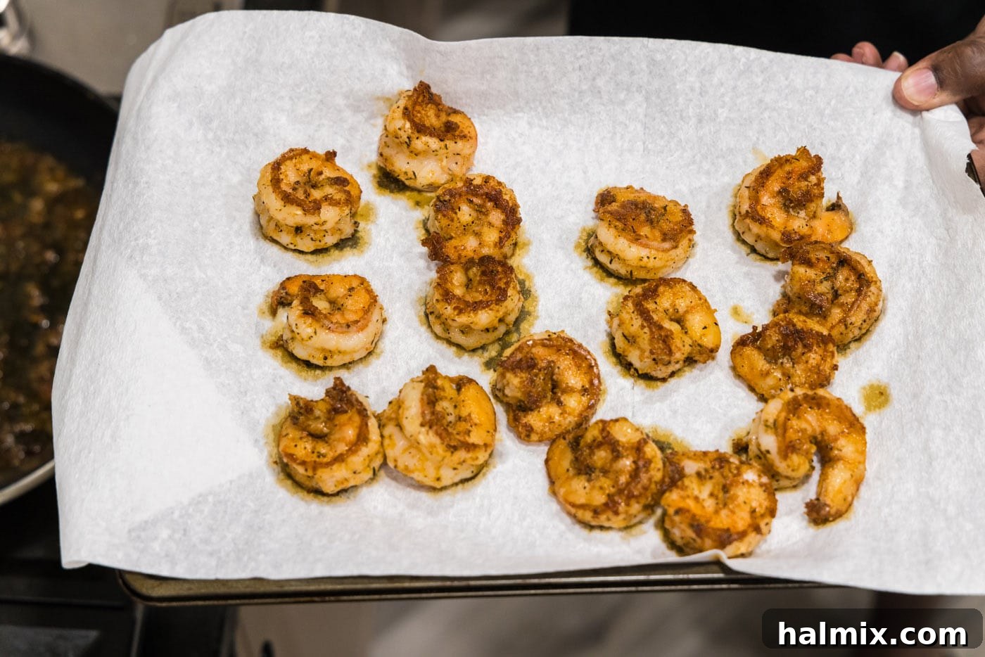 Cooked and seasoned shrimp resting on a paper towel, ready to be served.