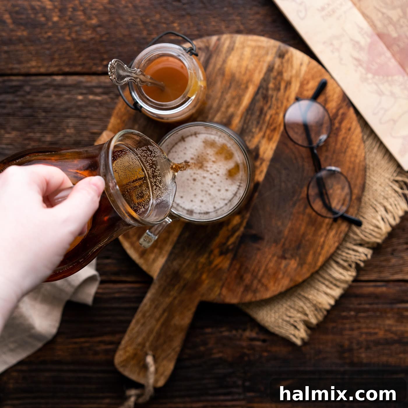 Cream soda being poured into a large glass mug, ready for the next magical ingredients.