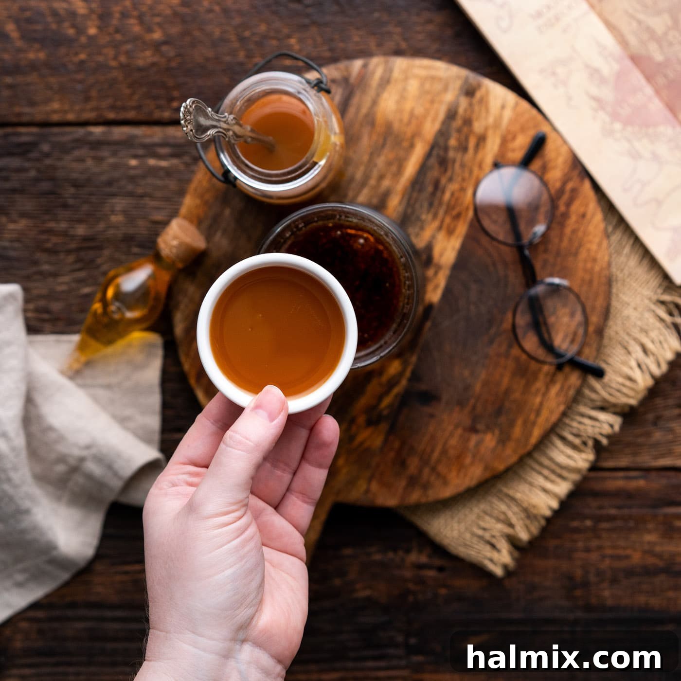 Golden butterscotch syrup being added to the cream soda, beginning to infuse the drink with its signature flavor.
