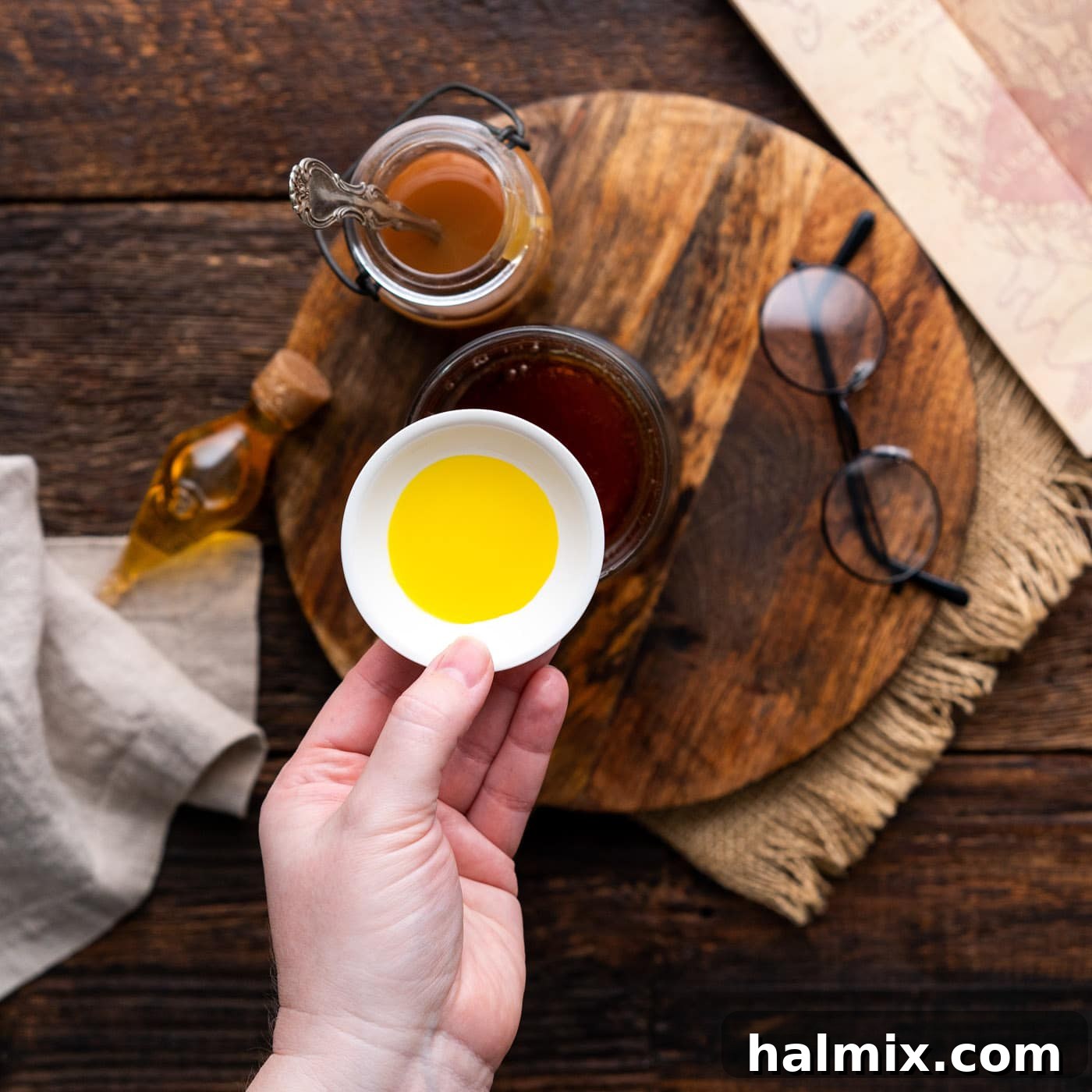 A few drops of butter extract being carefully added to the butterbeer mixture, enhancing its rich, buttery essence.