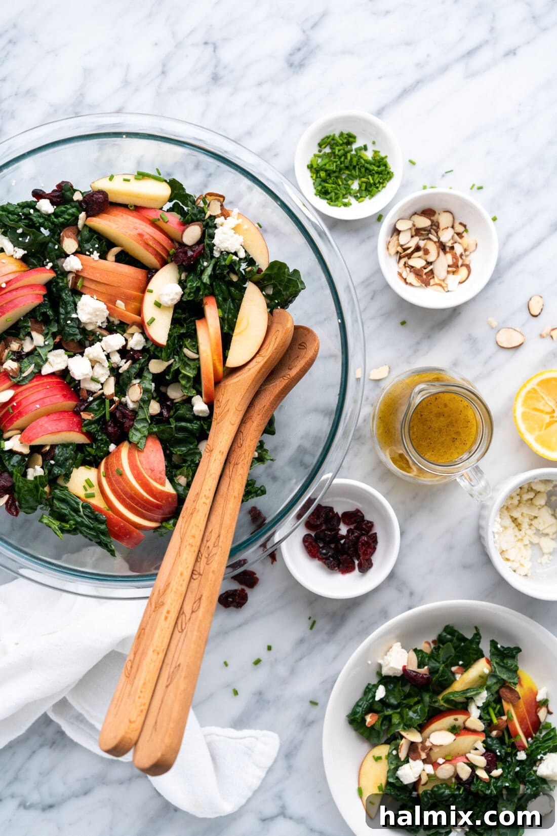 Bowl of kale salad with Lemon Salad Dressing and other topping on the side