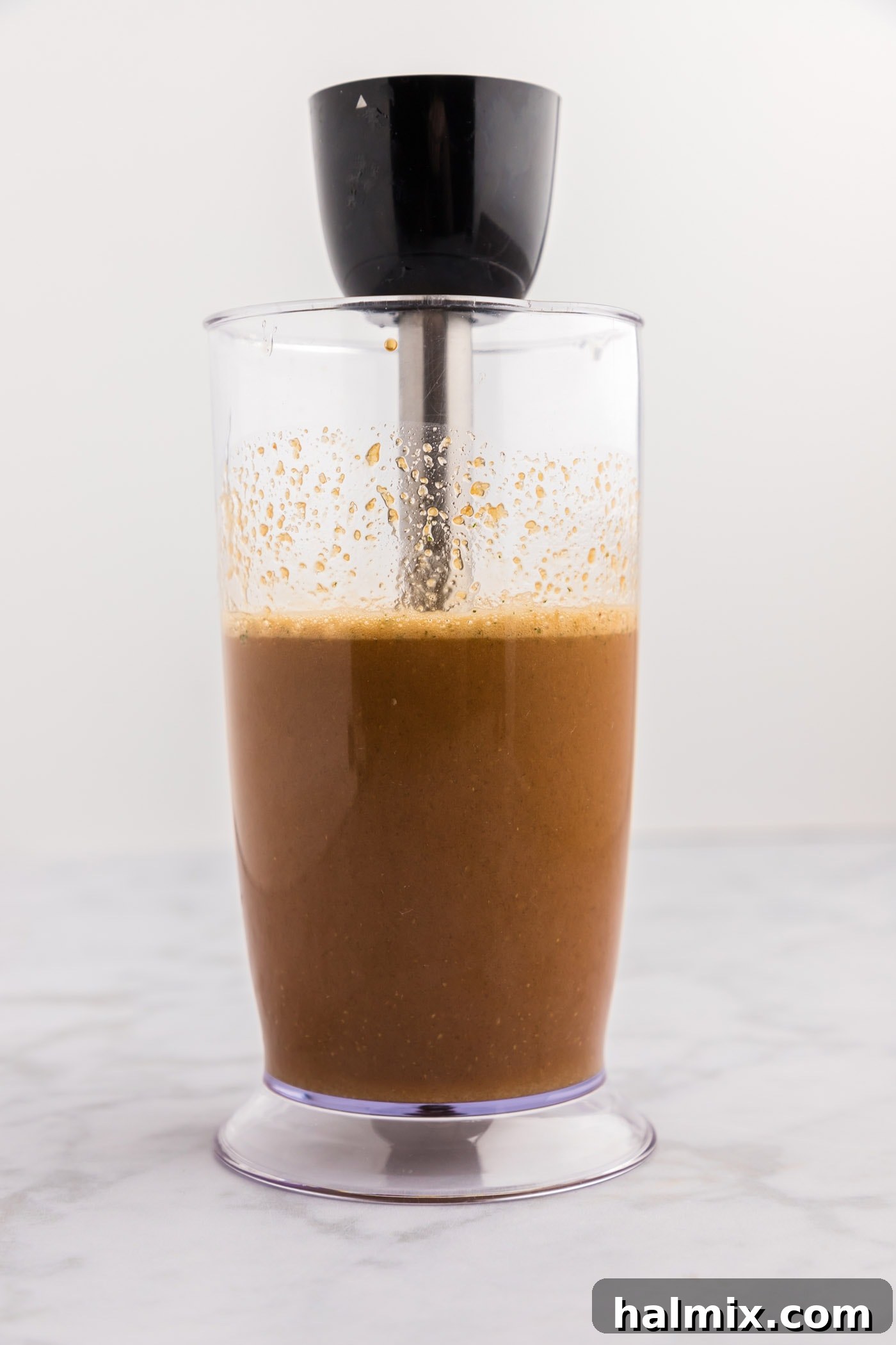 Sticky Sweet Honey Garlic Chicken Marinade 6 The honey garlic chicken marinade being blended with an immersion blender until smooth