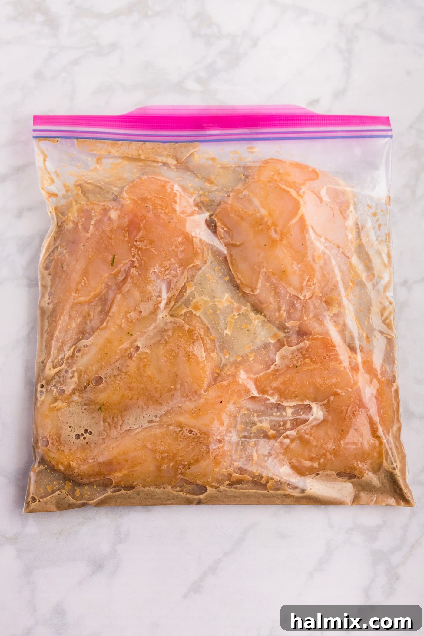 Sticky Sweet Honey Garlic Chicken Marinade 7 Chicken breasts marinating in honey garlic sauce in a zip-top bag