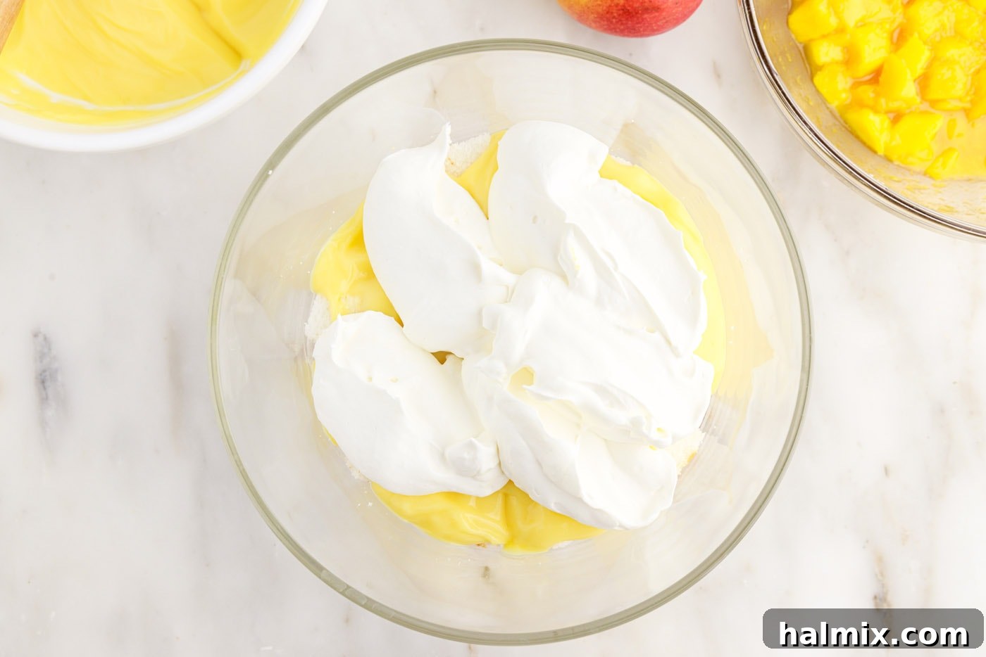 Whipped cream layer added over pudding and angel food cake