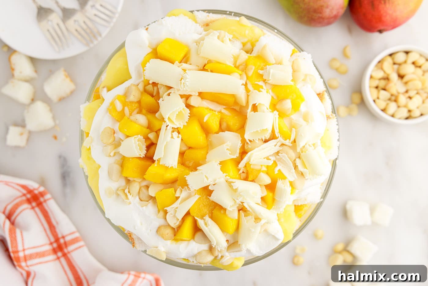 White chocolate shavings as a garnish over mango trifle