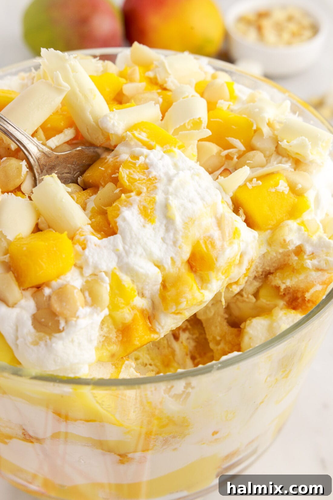 Mango Trifle being scooped out of the trifle dish, revealing the internal layers