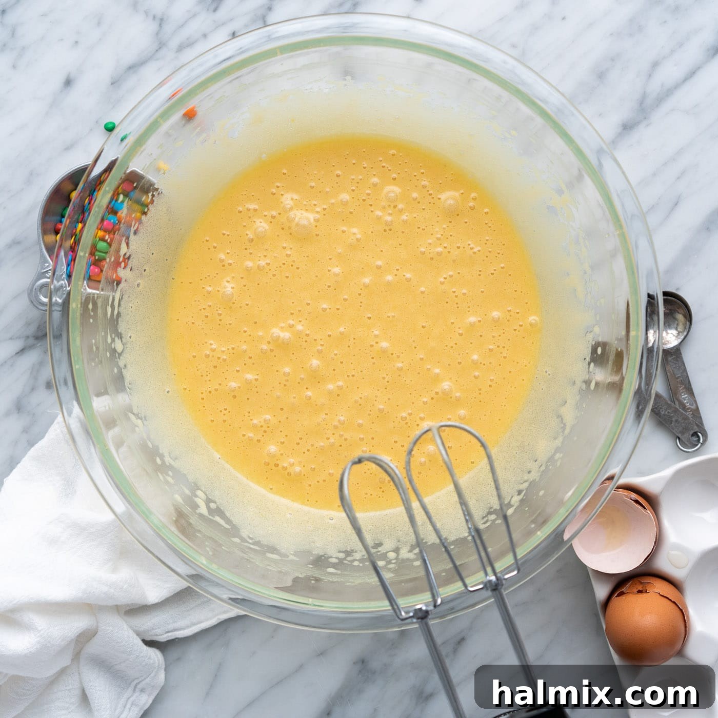 brownies wet ingredients in a bowl after being thoroughly beaten, showing a light, airy texture