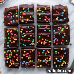 Overhead photo of Cosmic Brownies cut into squares, showcasing the colorful sprinkles and chocolate ganache.
