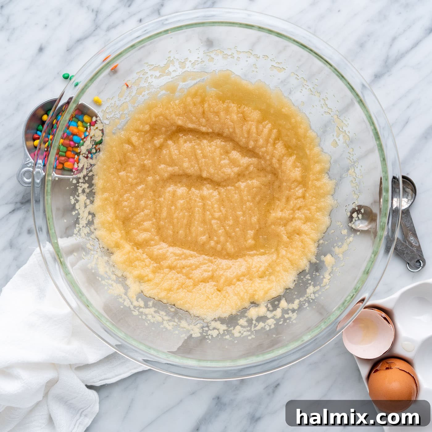 wet ingredients for brownies beaten to a fluffy consistency in a bowl