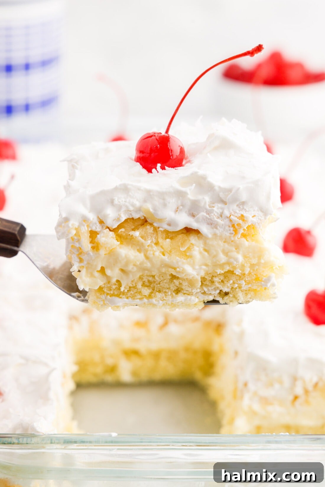 Piece of Millionaire Cake being lifted out of the pan, showcasing its rich layers
