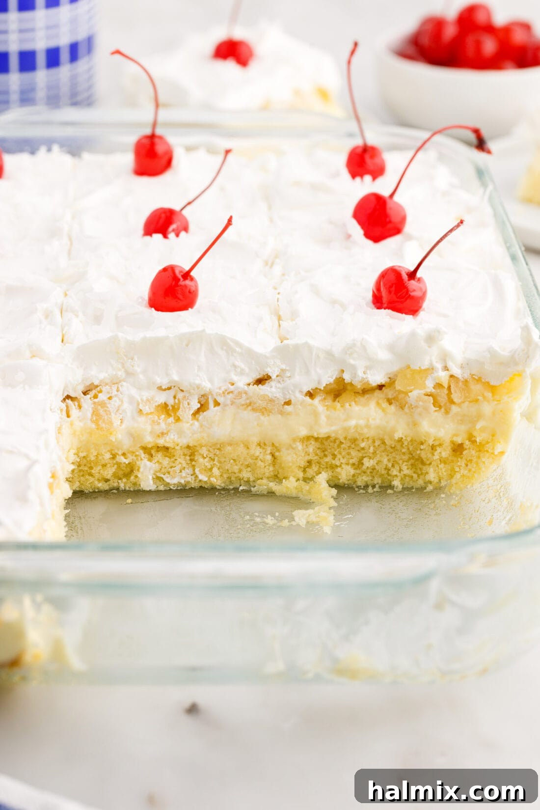Pan of Millionaire Cake with two pieces removed, showing the luscious layers