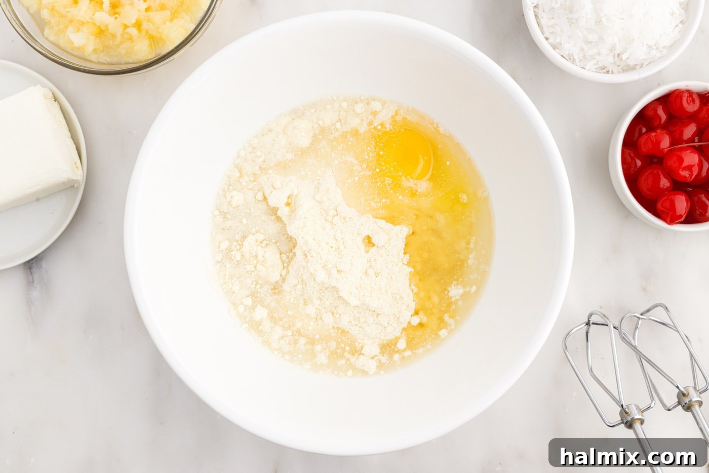 cake mix, eggs, water, and oil in a bowl, ready for mixing