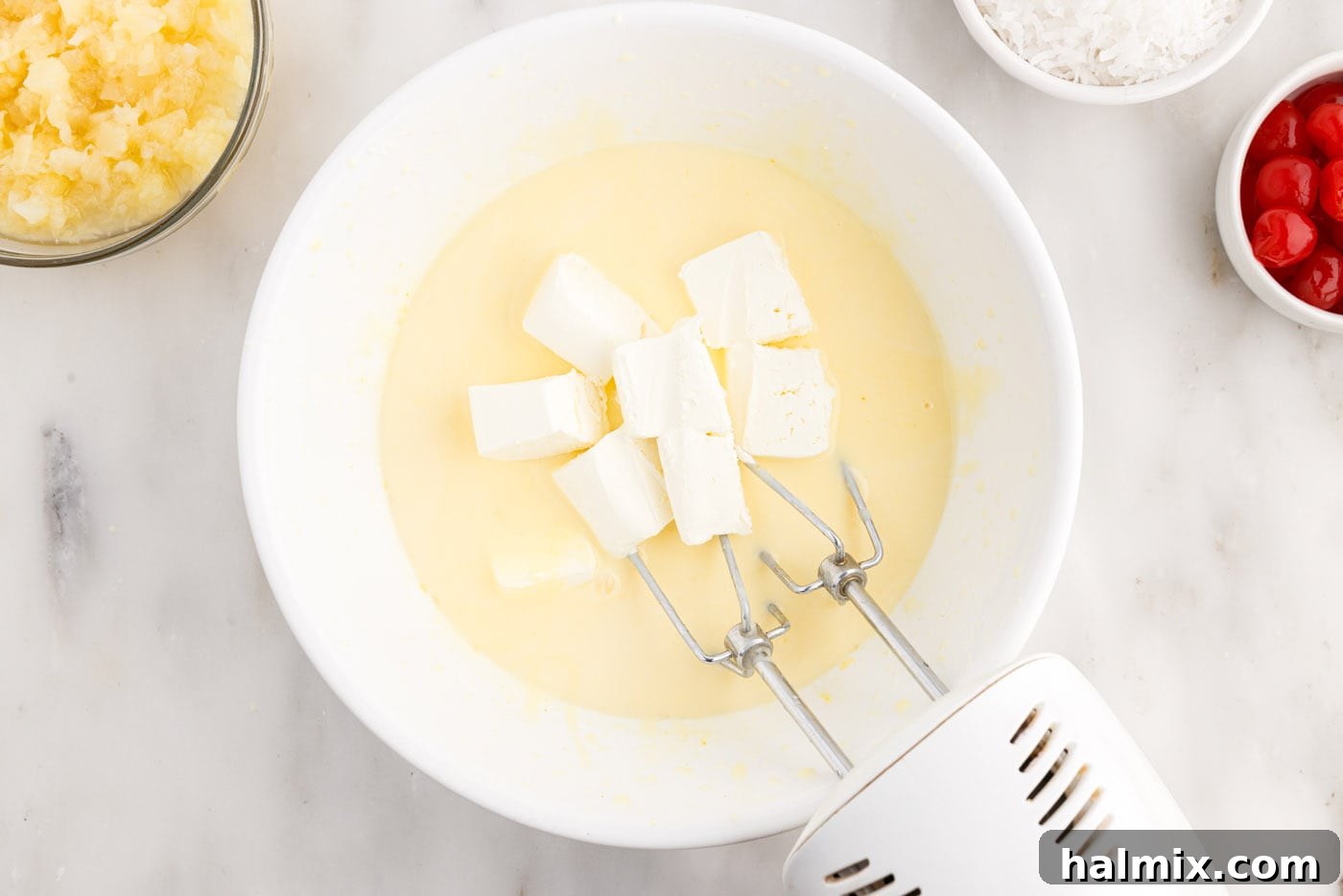 blending softened cream cheese into the pudding mix with a hand mixer