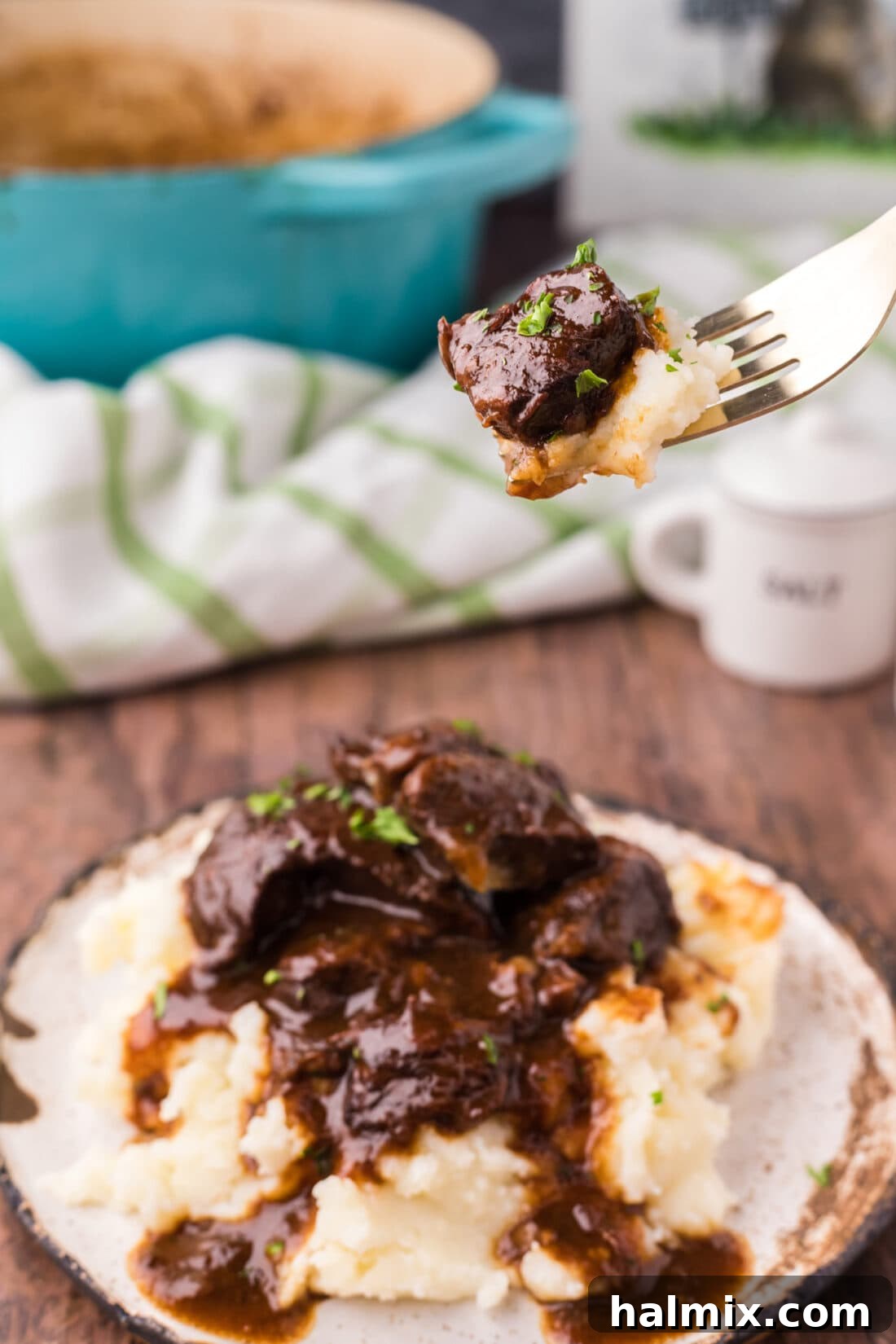 Savory Beef Bites in Velvety Gravy 2 Piece of Beef Tips and Gravy on a fork with mashed potatoes