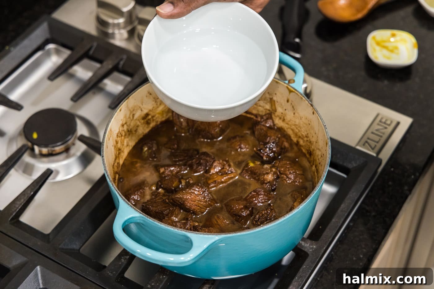 Savory Beef Bites in Velvety Gravy 11 adding water to pot with cubed chuck roast