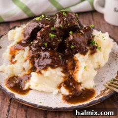 Savory Beef Bites in Velvety Gravy 14 Close up photo of Beef Tips and Gravy served over mashed potatoes