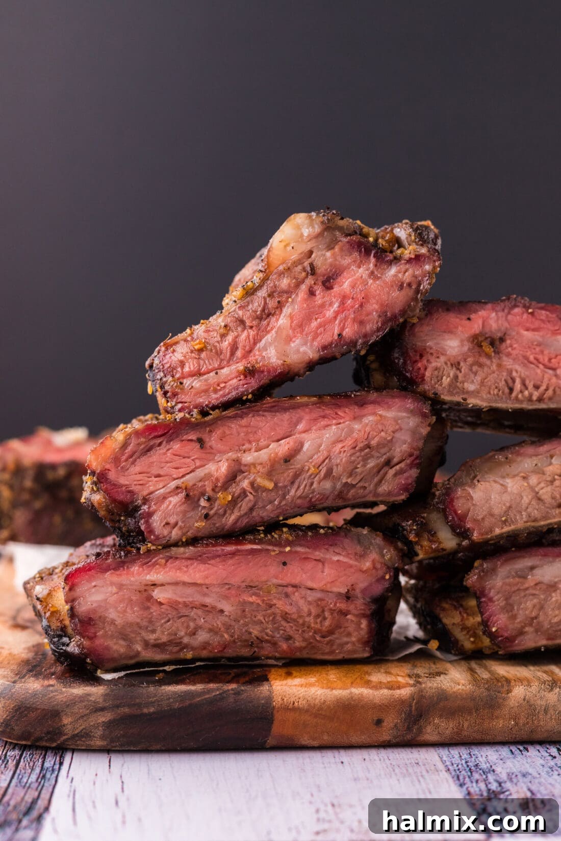 Fall-Off-The-Bone Smoked Beef Ribs 11 A generous stack of perfectly smoked beef ribs, showcasing the crispy bark and tender meat.