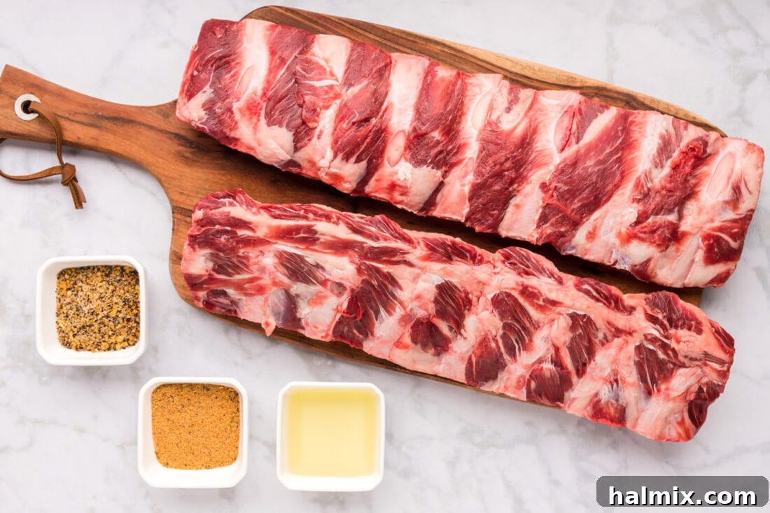 Fall-Off-The-Bone Smoked Beef Ribs 4 A collection of ingredients laid out for Smoked Beef Ribs, including ribs, olive oil, seasonings, apple cider vinegar, water, and hot sauce.