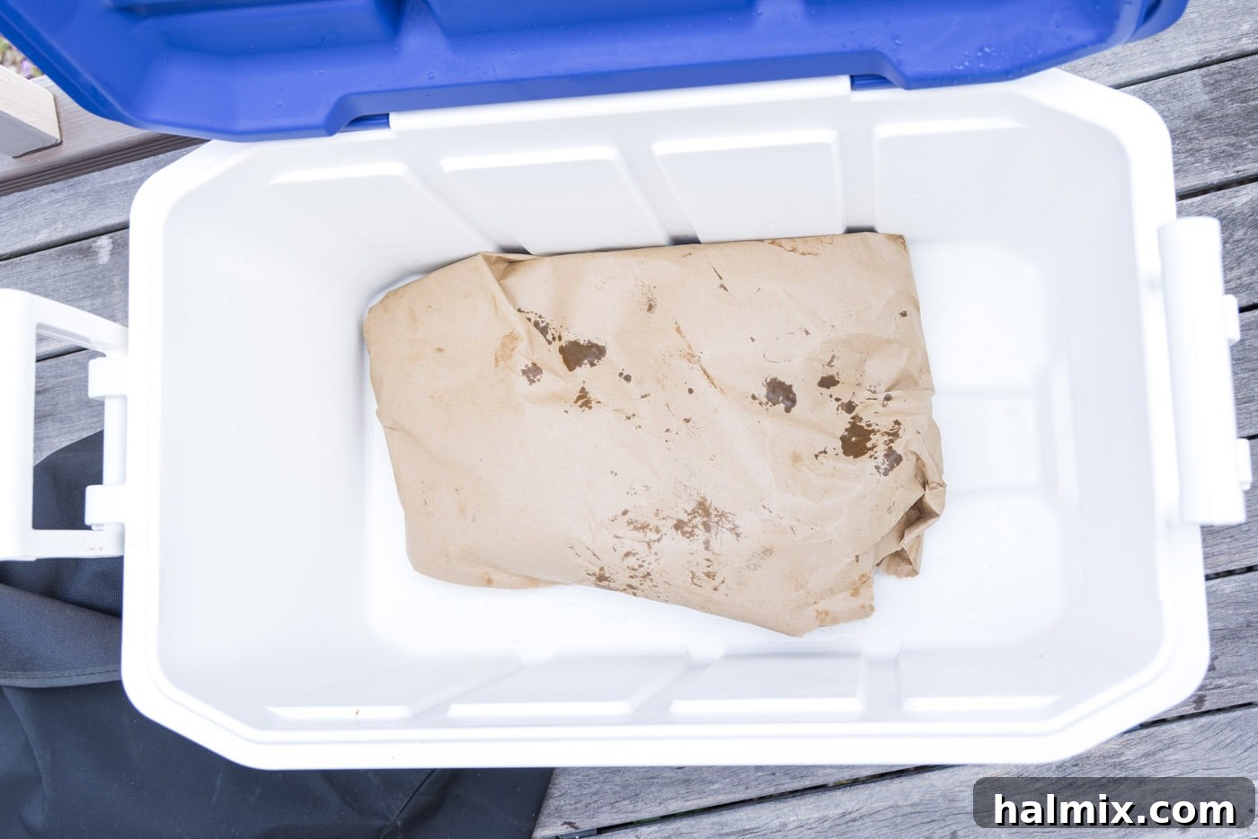 Fall-Off-The-Bone Smoked Beef Ribs 10 Wrapped beef ribs placed inside an empty cooler, insulating them during the crucial resting period.