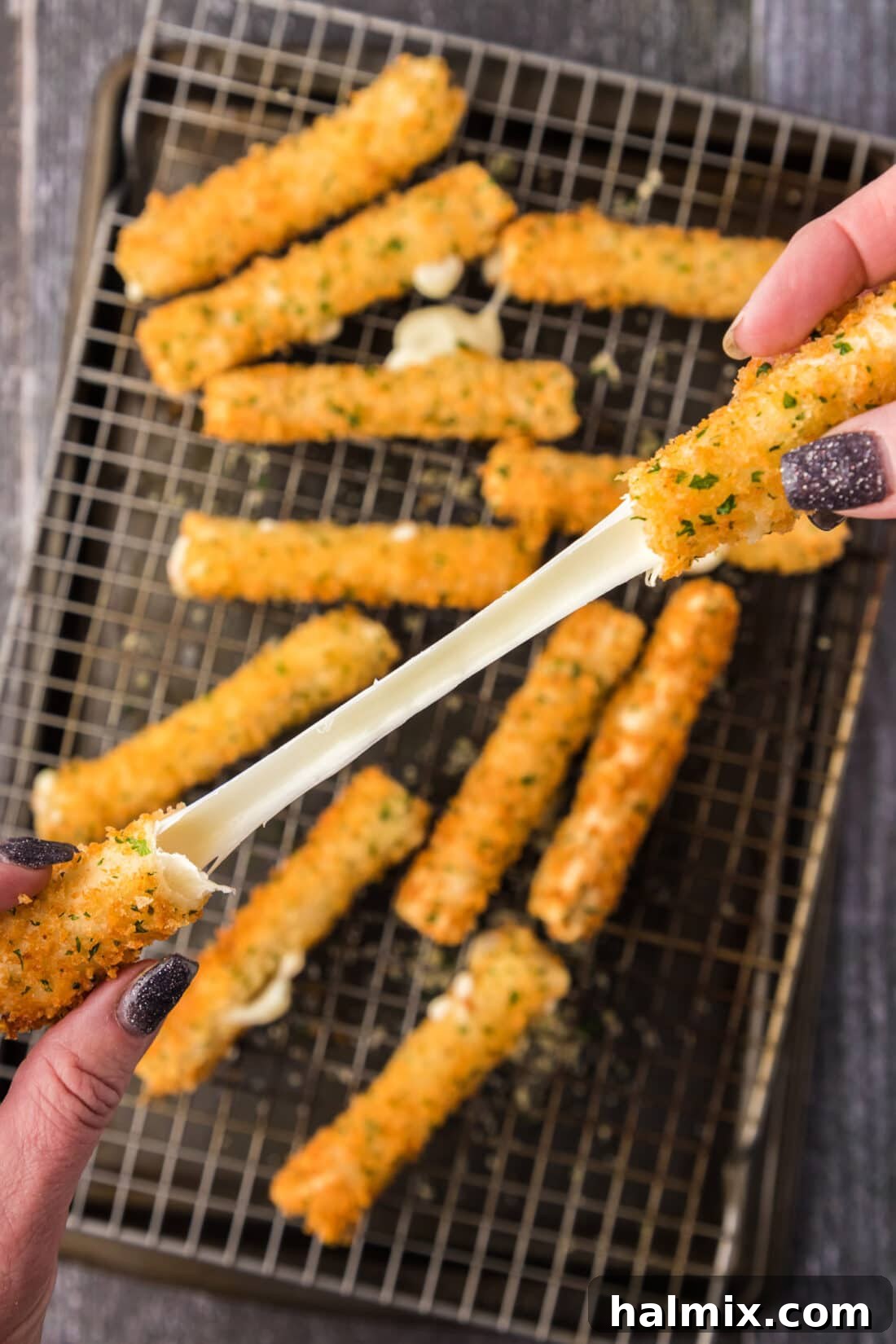 Crispy Wonton Cheese Bites 3 Wonton Cheese Stick cheese pull over a pan of Wonton Cheese Sticks