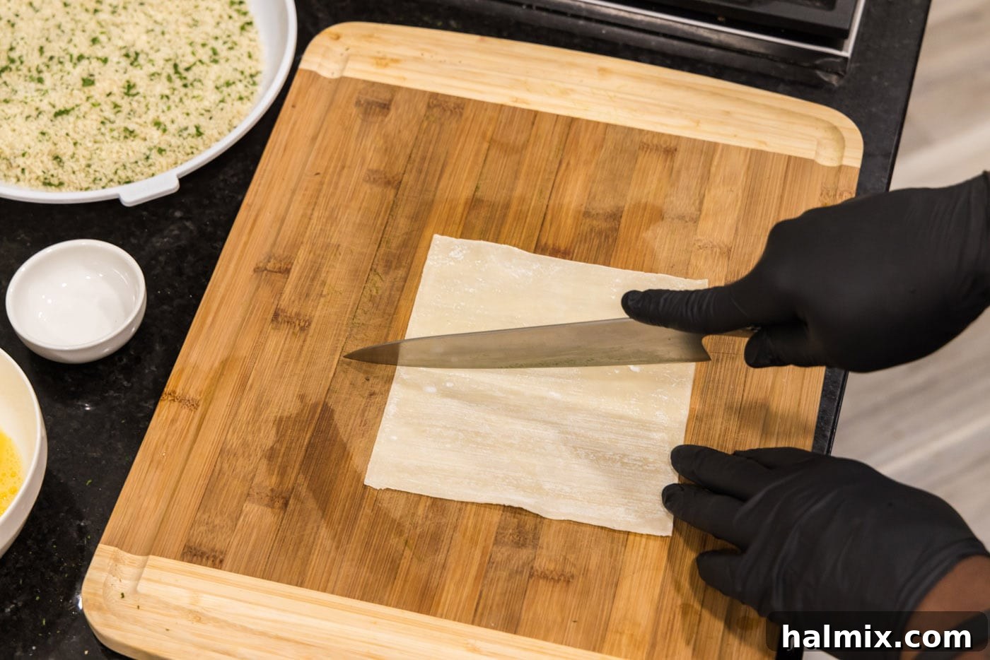 Crispy Wonton Cheese Bites 7 slicing egg roll wrapper in half