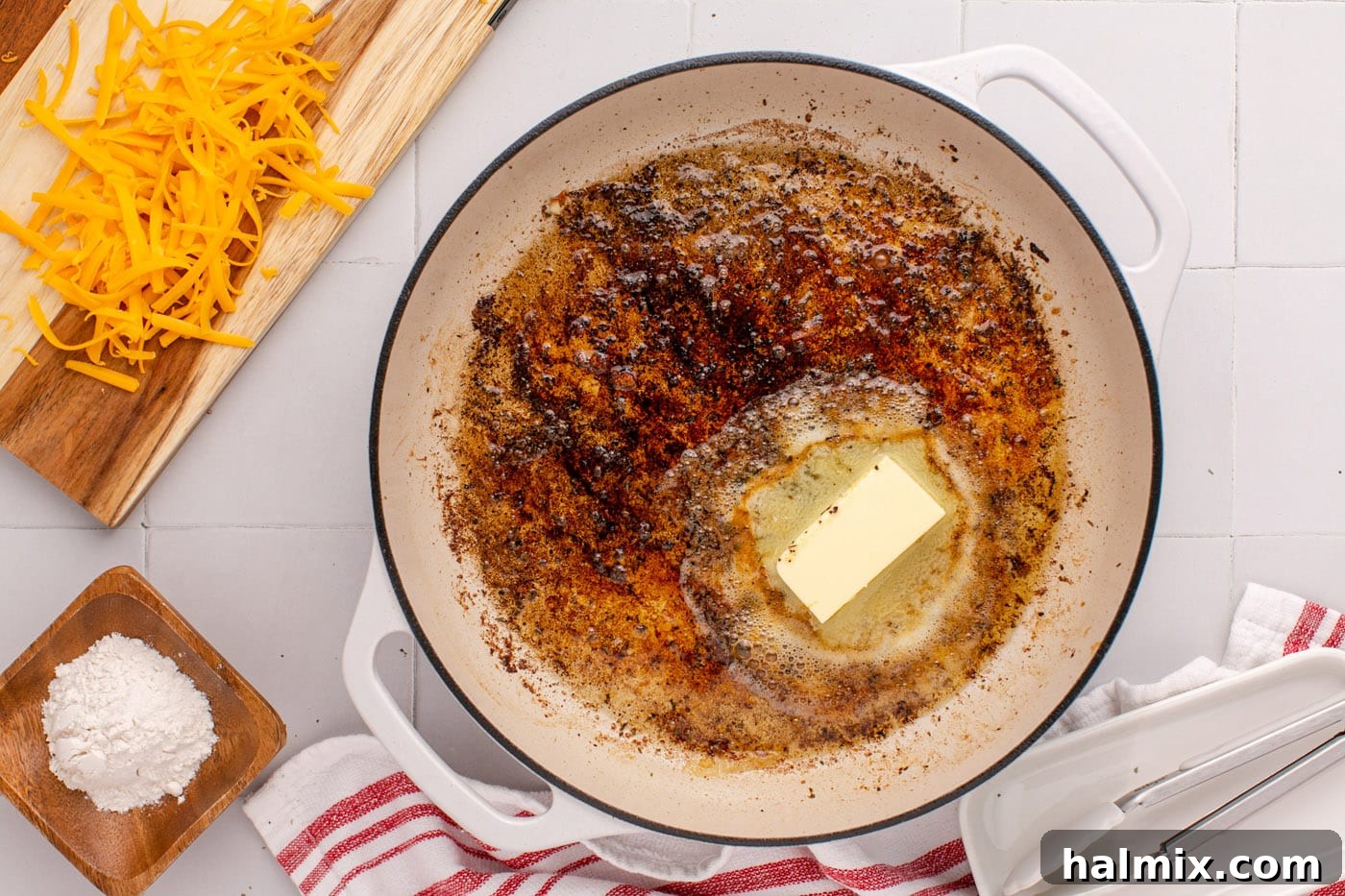 Remaining butter added to the skillet, mingling with chicken drippings.
