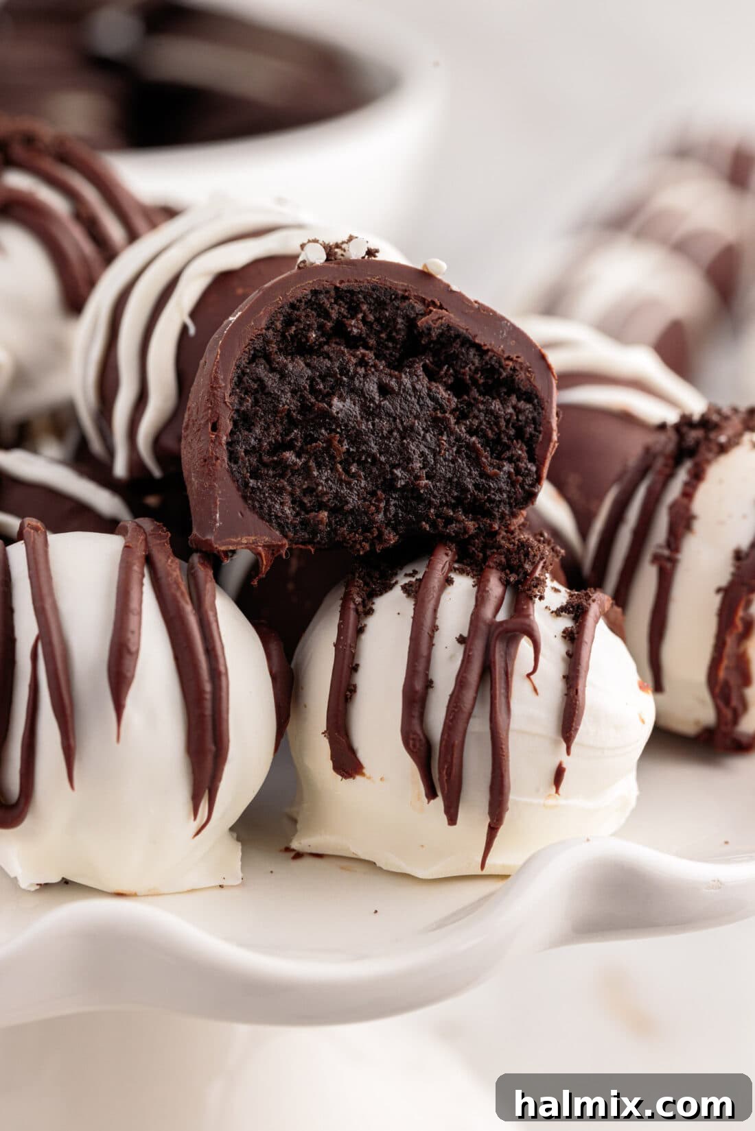 Close up photo of an Oreo Truffle with a bite out of it, showcasing its creamy cookie crumb interior.