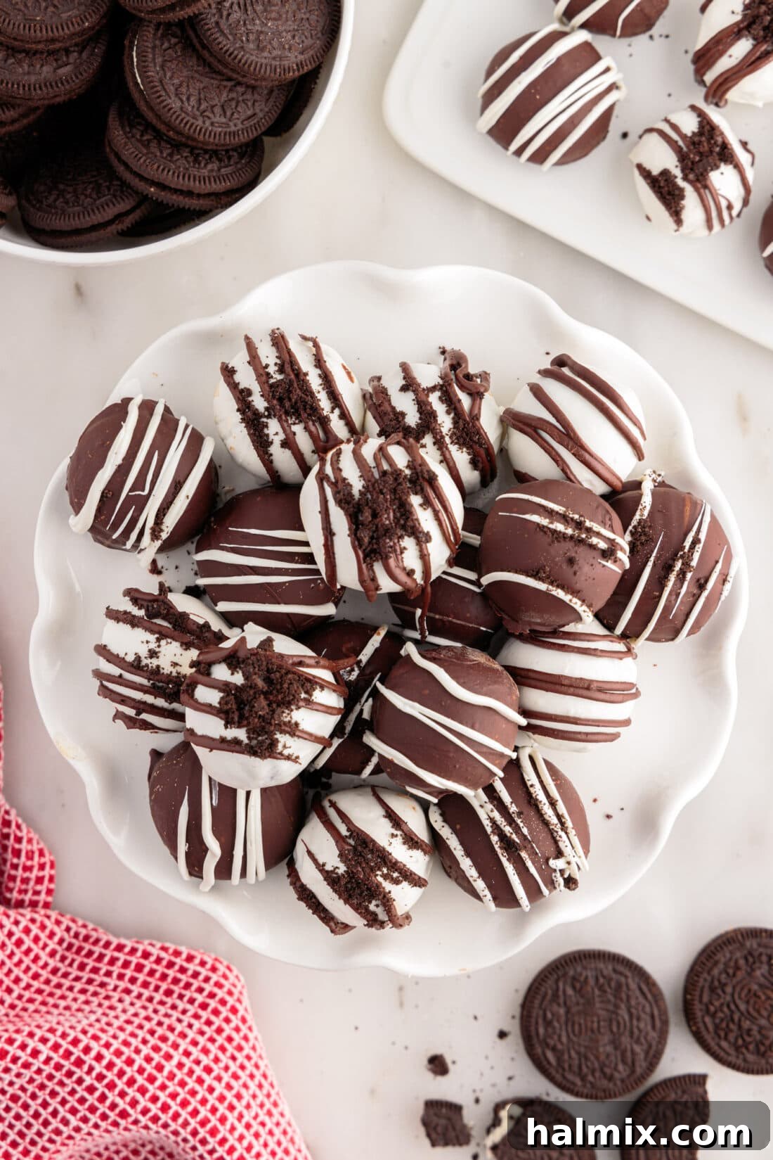 Oreo Truffles stacked on a white serving tray, ready for a party.