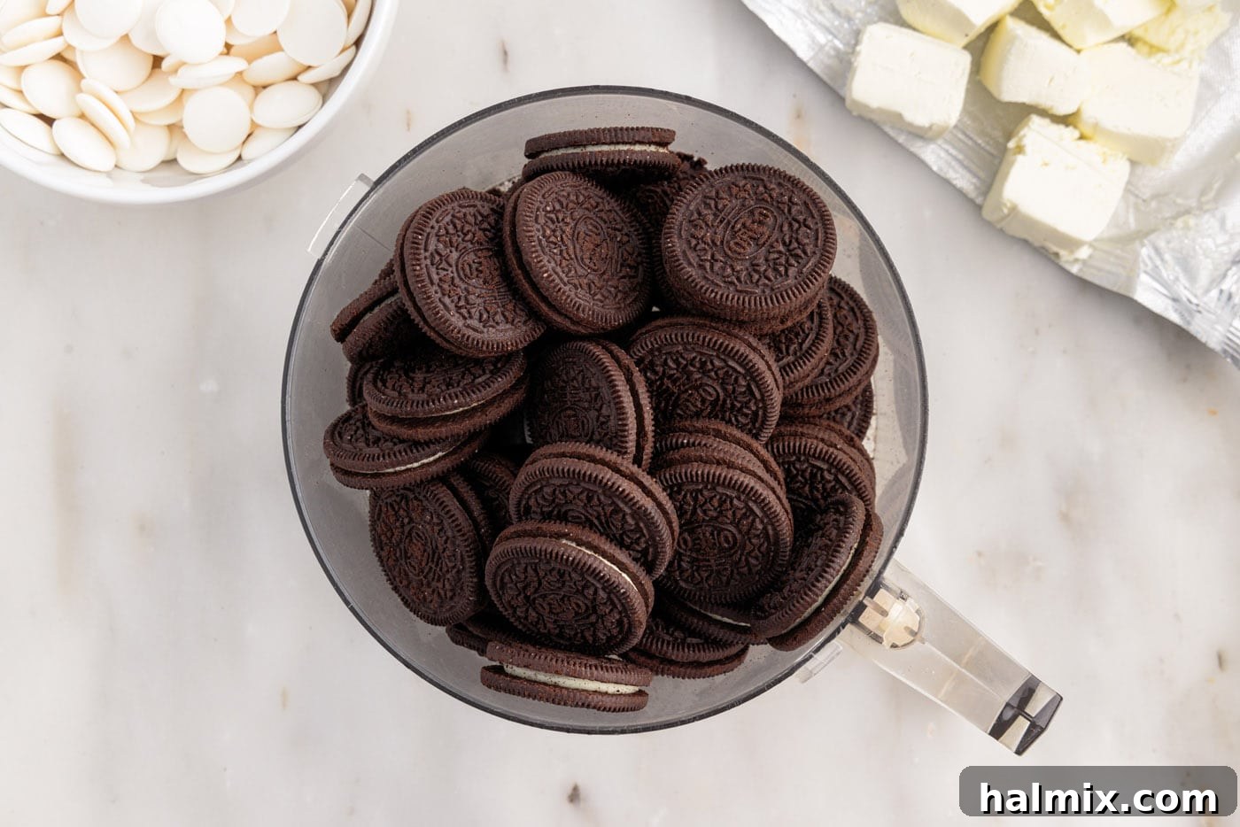oreo cookies in a food processor, being turned into fine crumbs