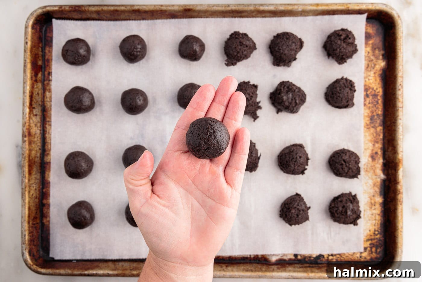 rolling oreo mixture into a smooth ball between hands