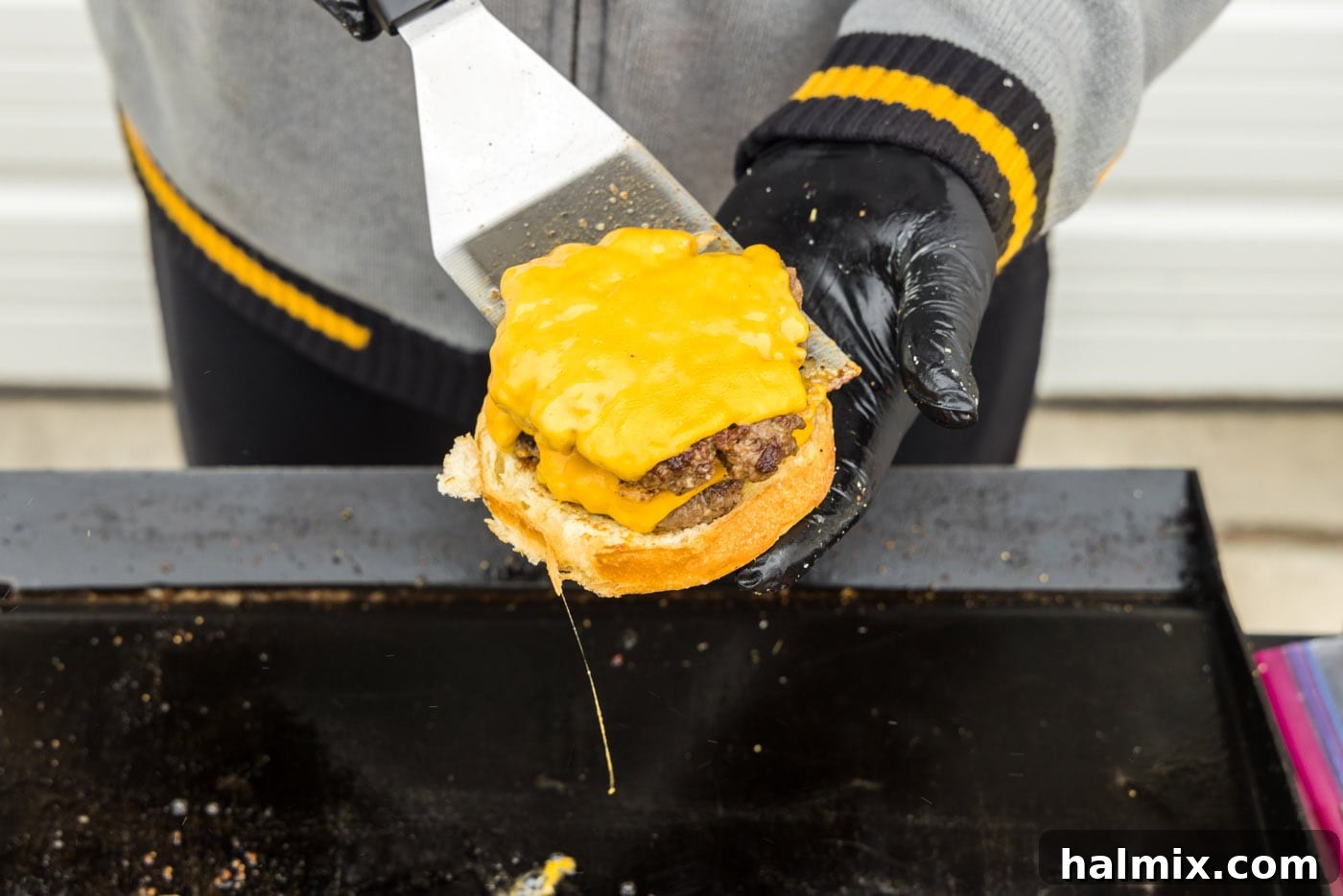 A double smash burger with cheese, stacked on a bun