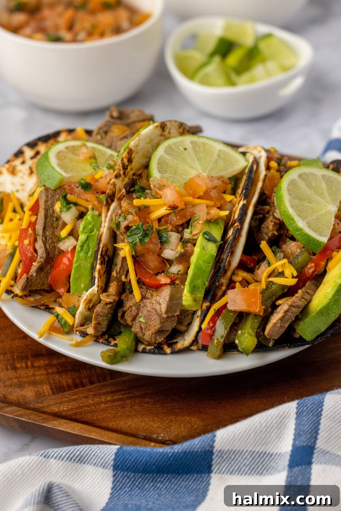 Steak Fajitas wrapped in tortillas served on a plate