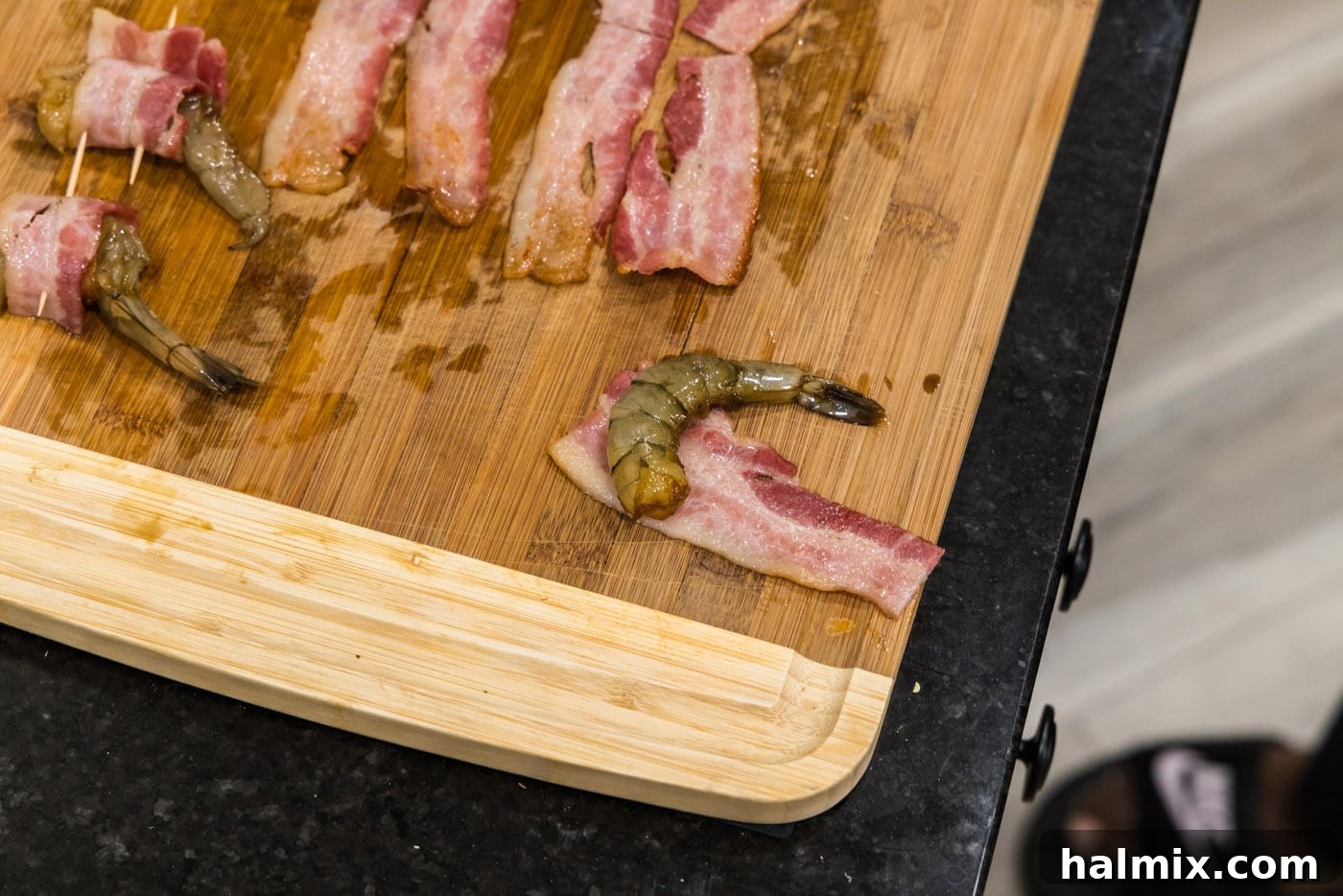 The Ultimate Surf and Turf Appetizer 11 shrimp placed on top of bacon