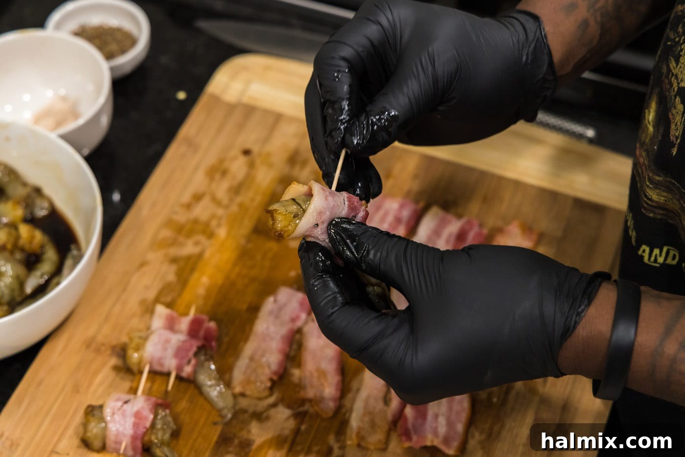 The Ultimate Surf and Turf Appetizer 12 securing bacon wrapped shrimp with a toothpick