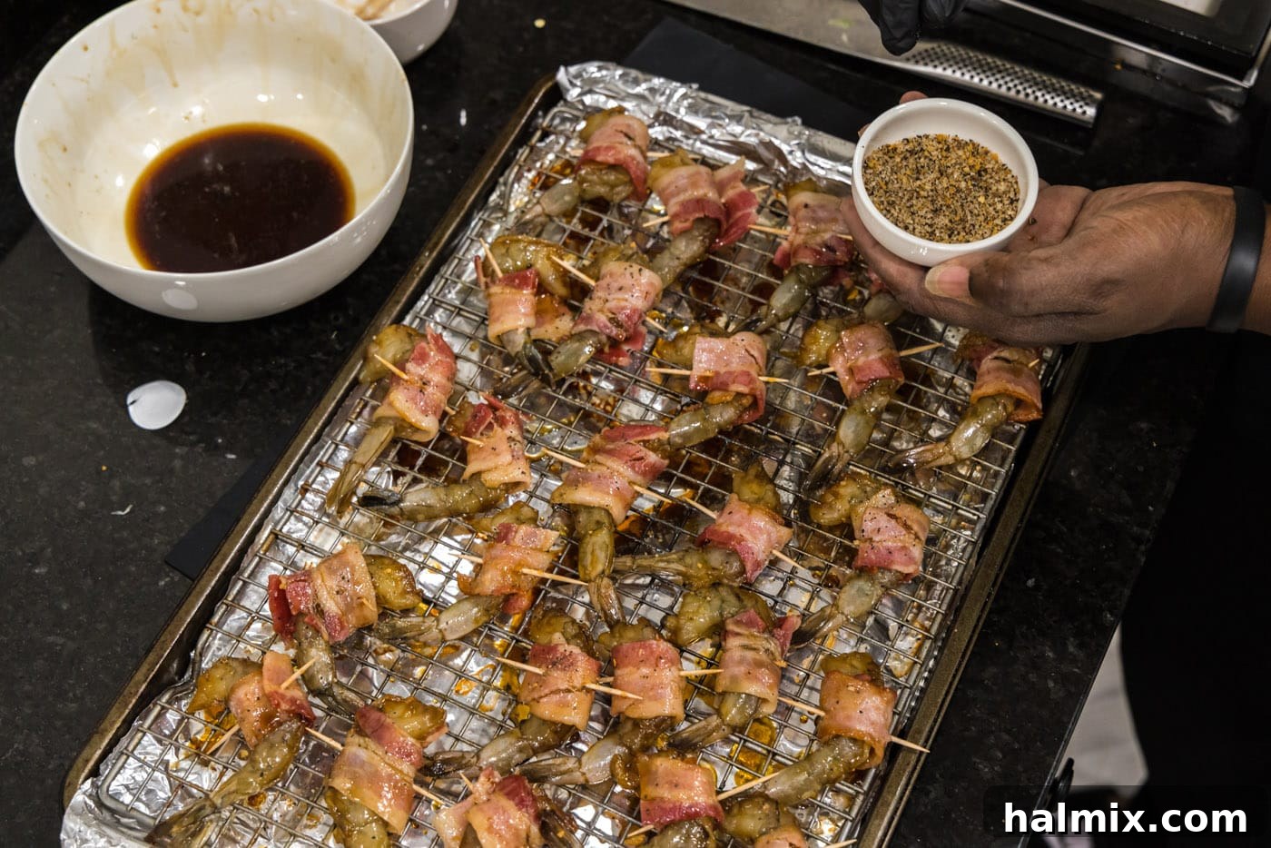 The Ultimate Surf and Turf Appetizer 14 seasoning bacon shrimp on a baking sheet