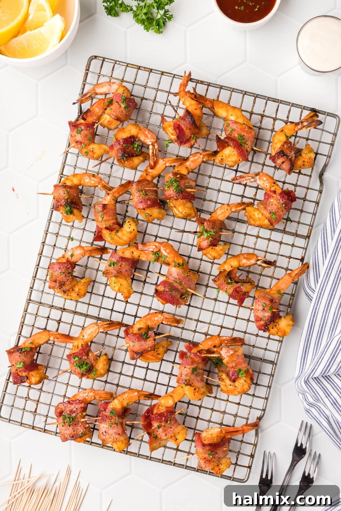 The Ultimate Surf and Turf Appetizer 16 Bacon Wrapped Shrimp resting on a wire rack