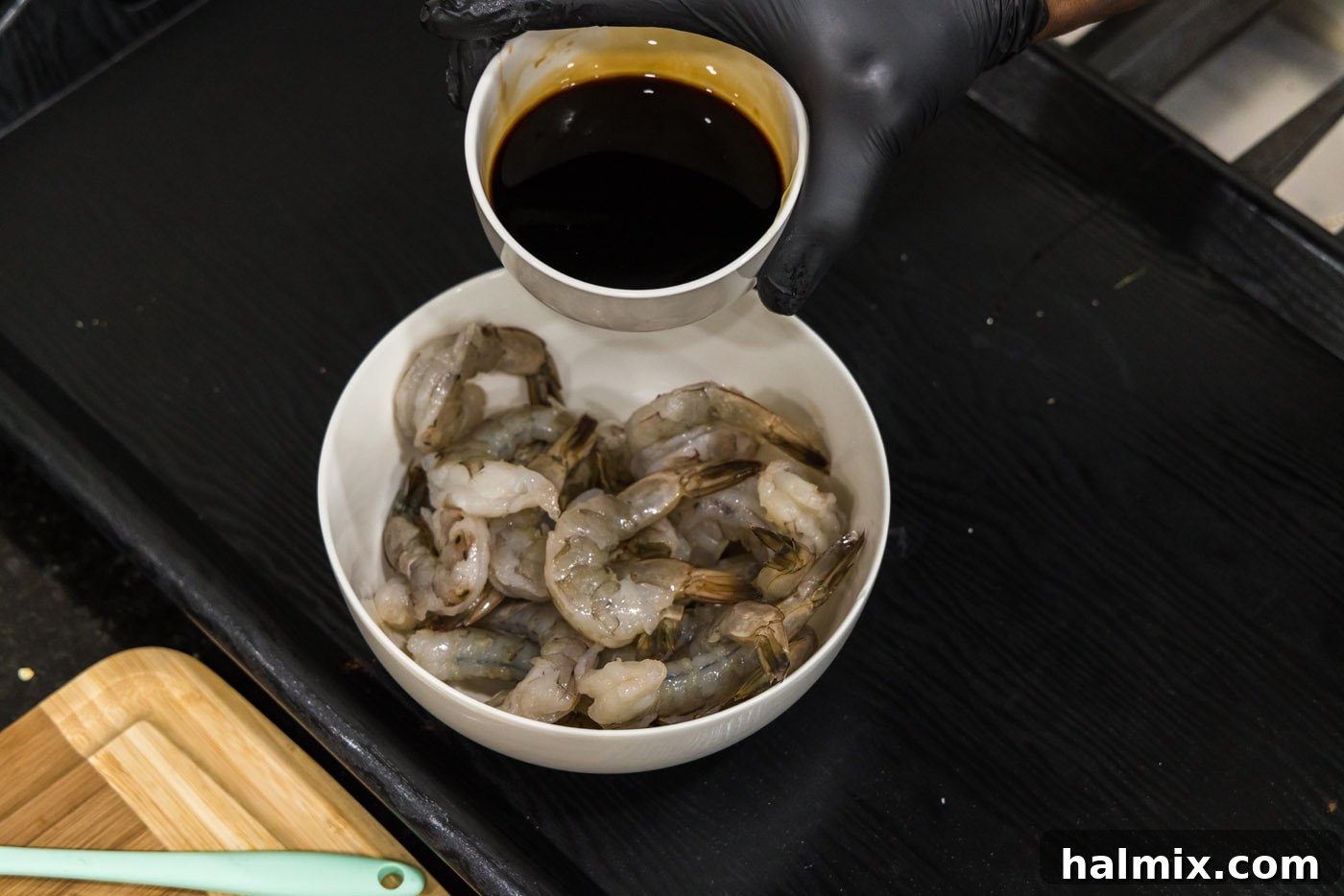 The Ultimate Surf and Turf Appetizer 8 pouring soy sauce honey glaze over shrimp