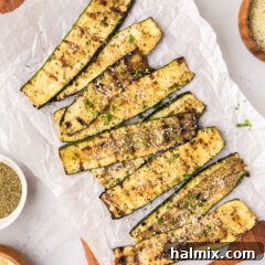 Grilled Zucchini on a wooden platter topped with parmesan cheese
