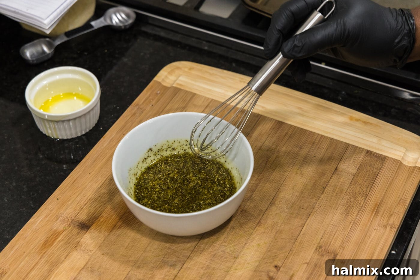 whisking grilled zucchini seasonings with oil