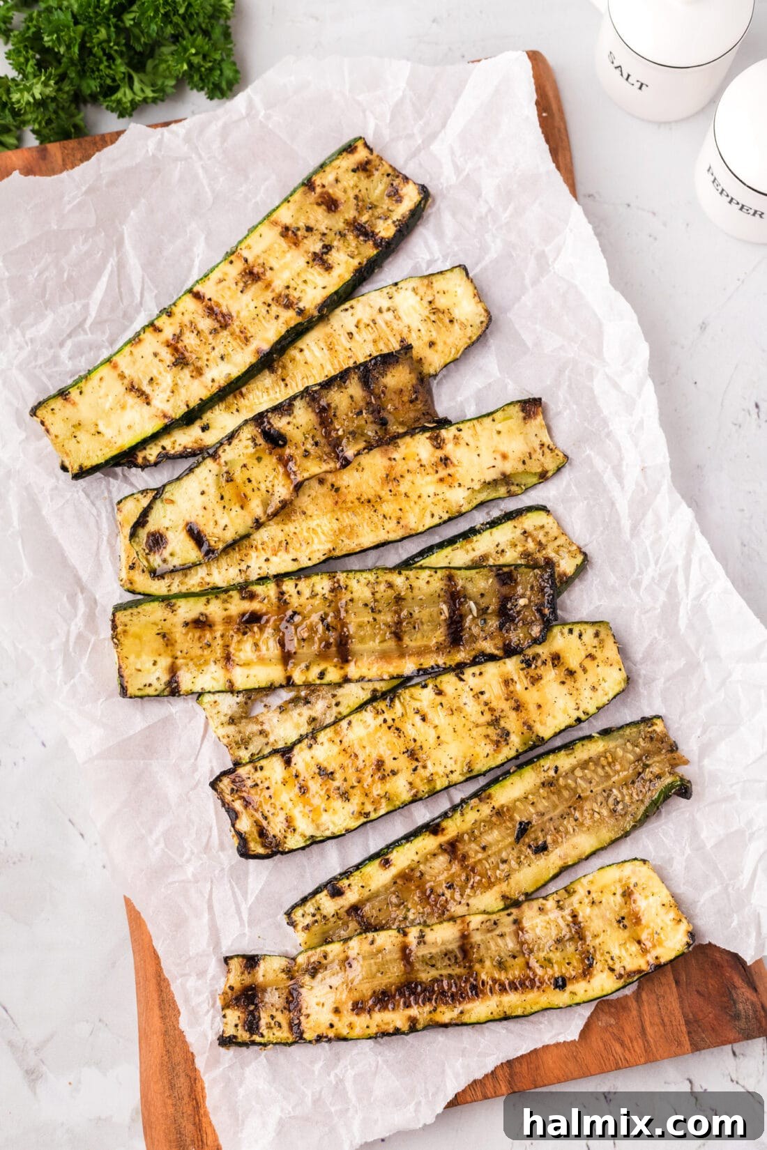 Grilled Zucchini on a wooden platter with parchment