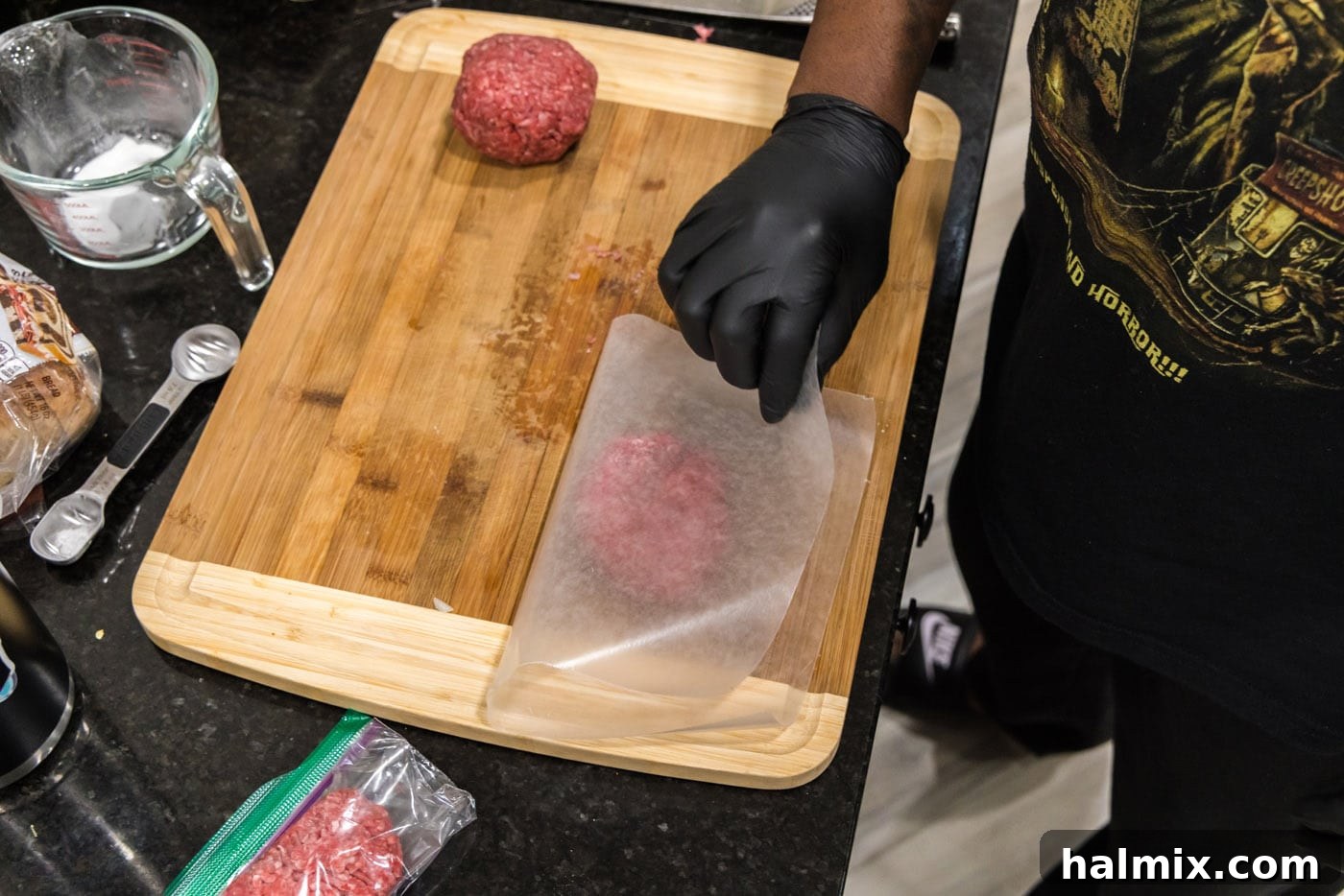 placing parchment paper over burger meat