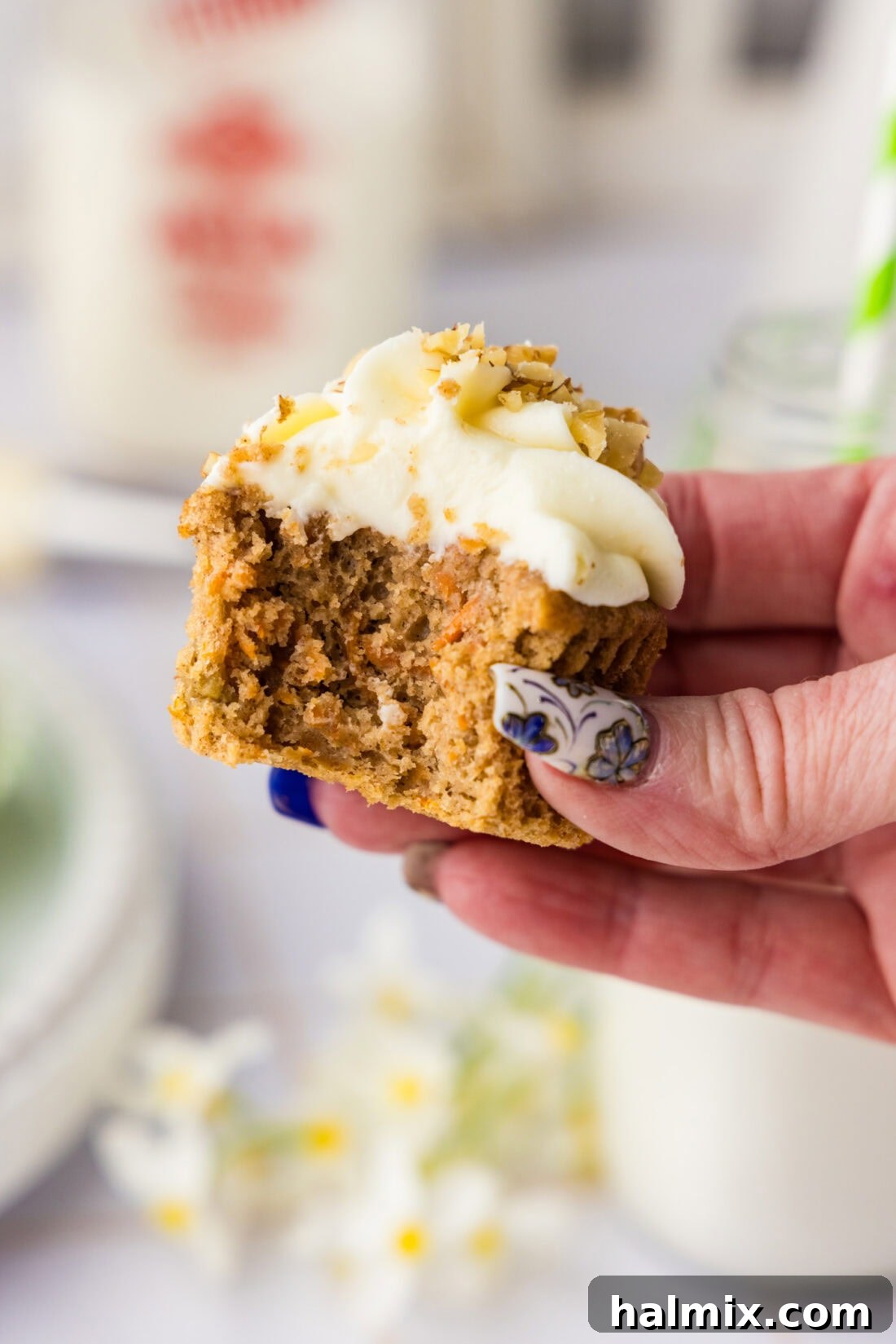Decadent Carrot Cupcakes 11 Hand holding a Carrot Cupcake with a bite taken out