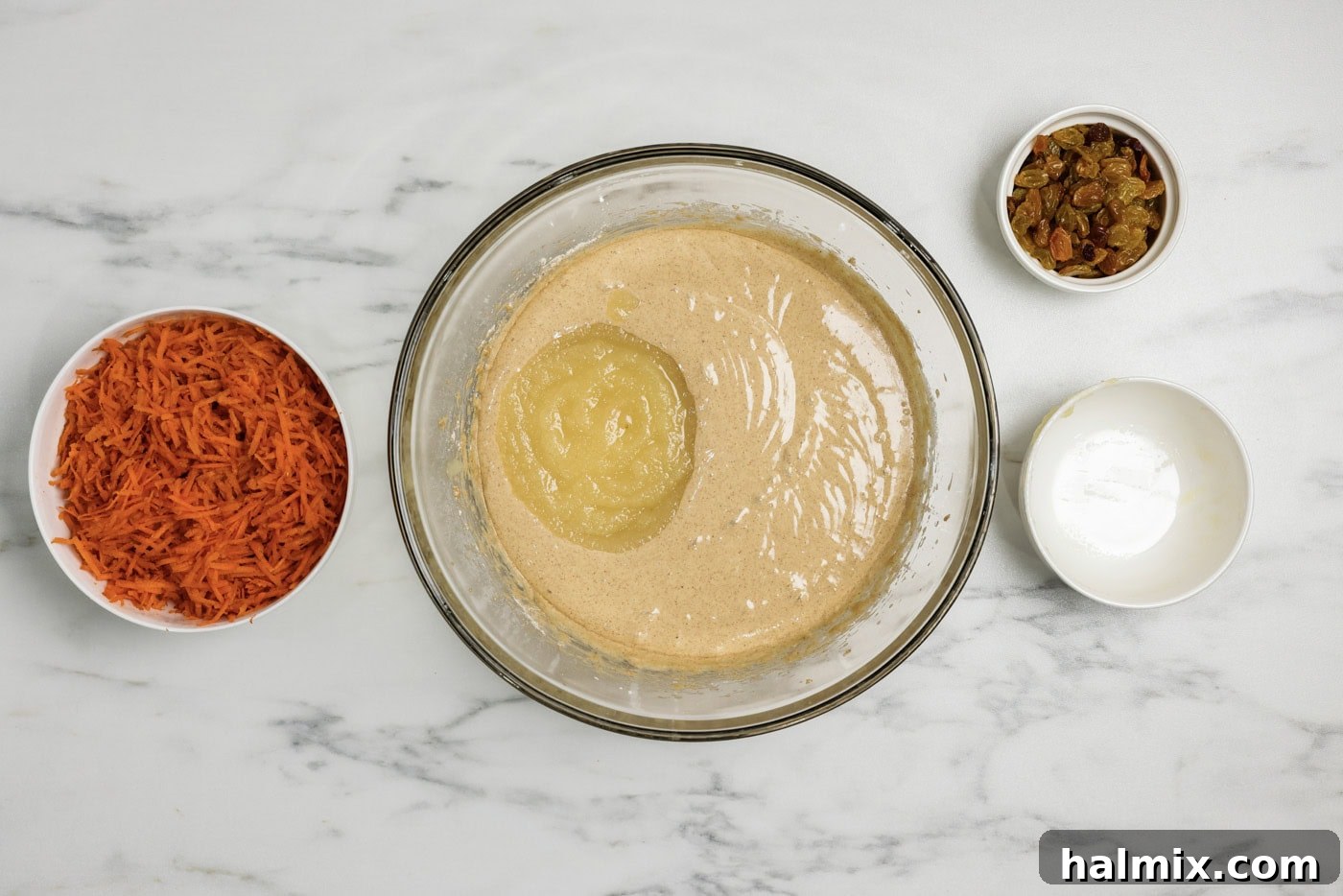 Decadent Carrot Cupcakes 5 applesauce added to spice cake batter in a bowl