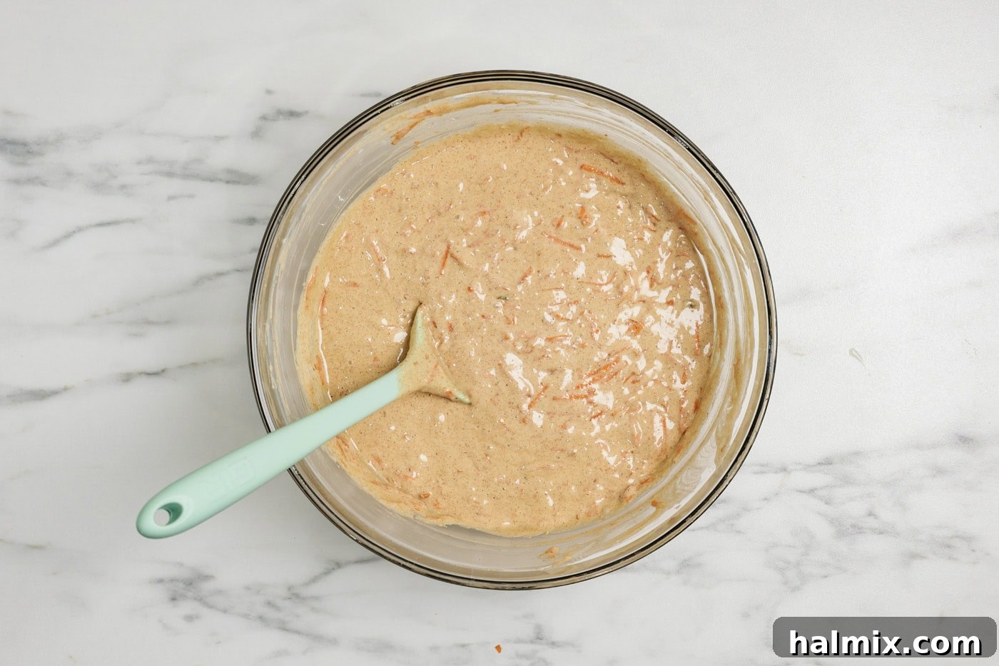 Decadent Carrot Cupcakes 7 carrot cupcake batter in a bowl with a rubber spatula