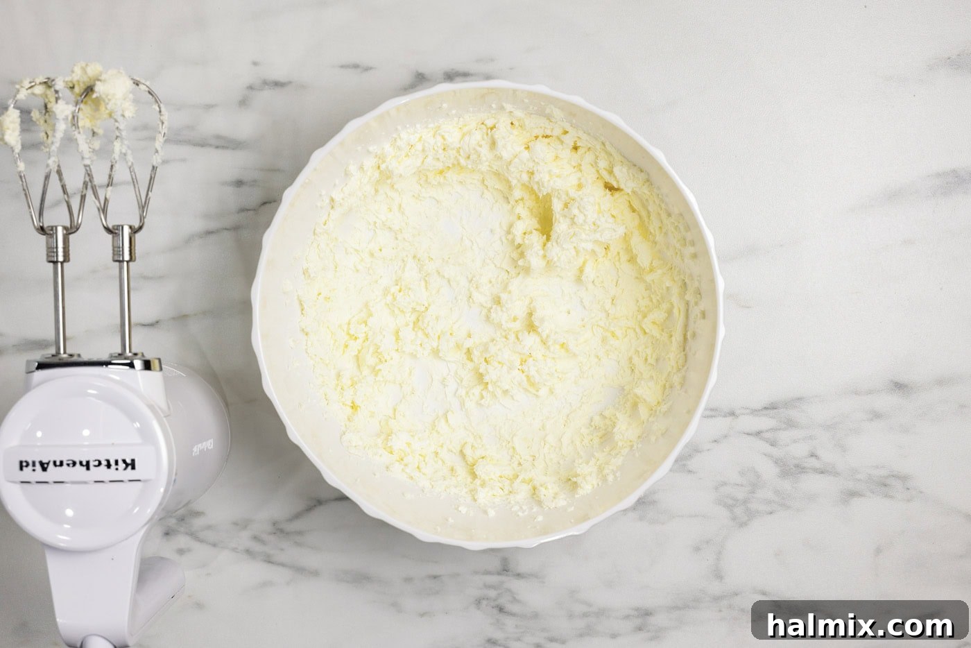 Decadent Carrot Cupcakes 9 butter and cream cheese beaten in a bowl with a hand mixer