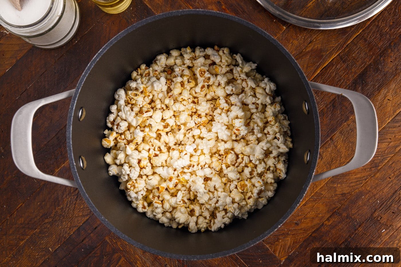 Kettle corn popping on the stovetop, pan being shaken