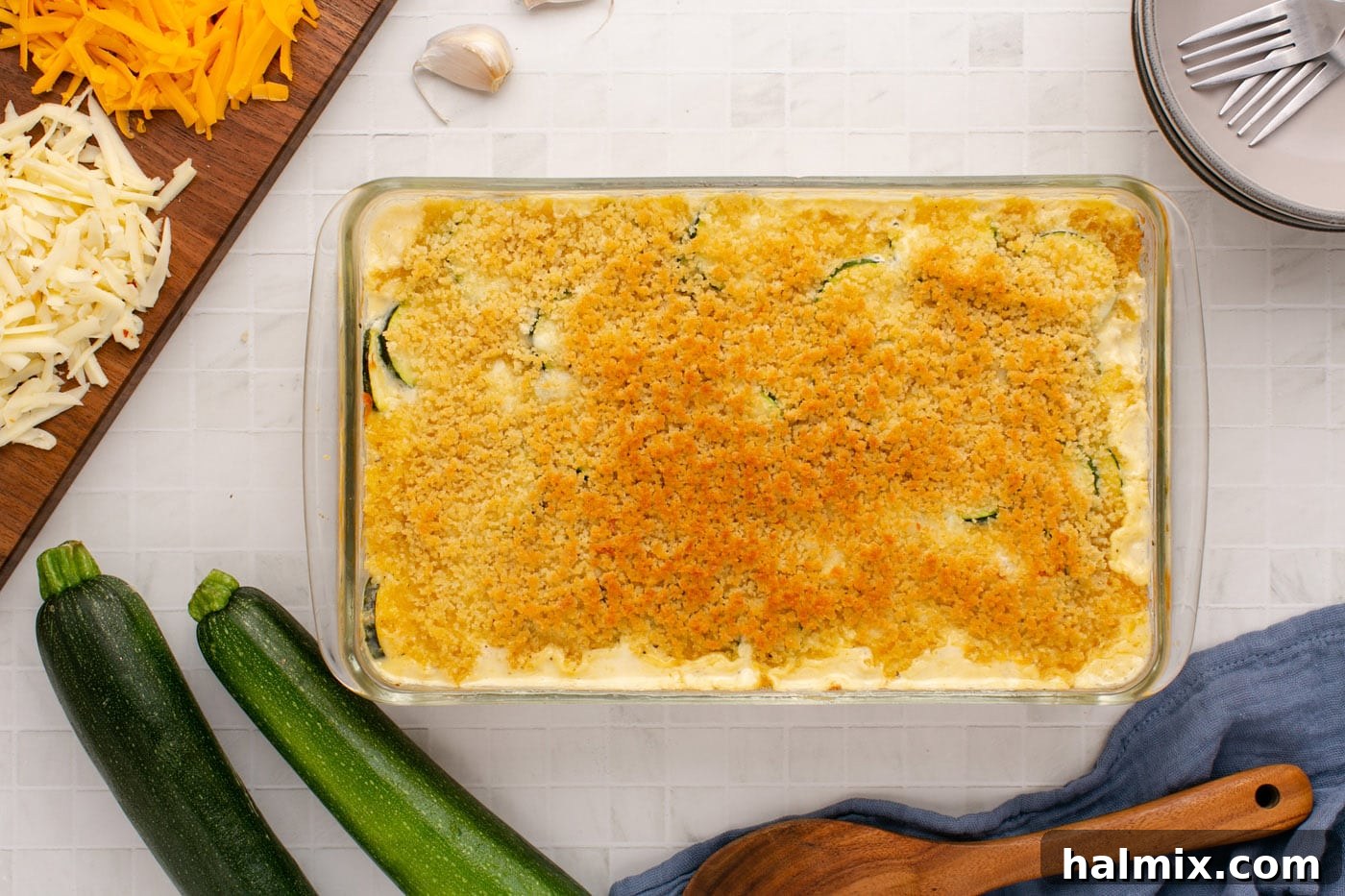 The finished baked zucchini casserole, glistening with a golden-brown, crispy panko topping, fresh out of the oven and ready to be served.
