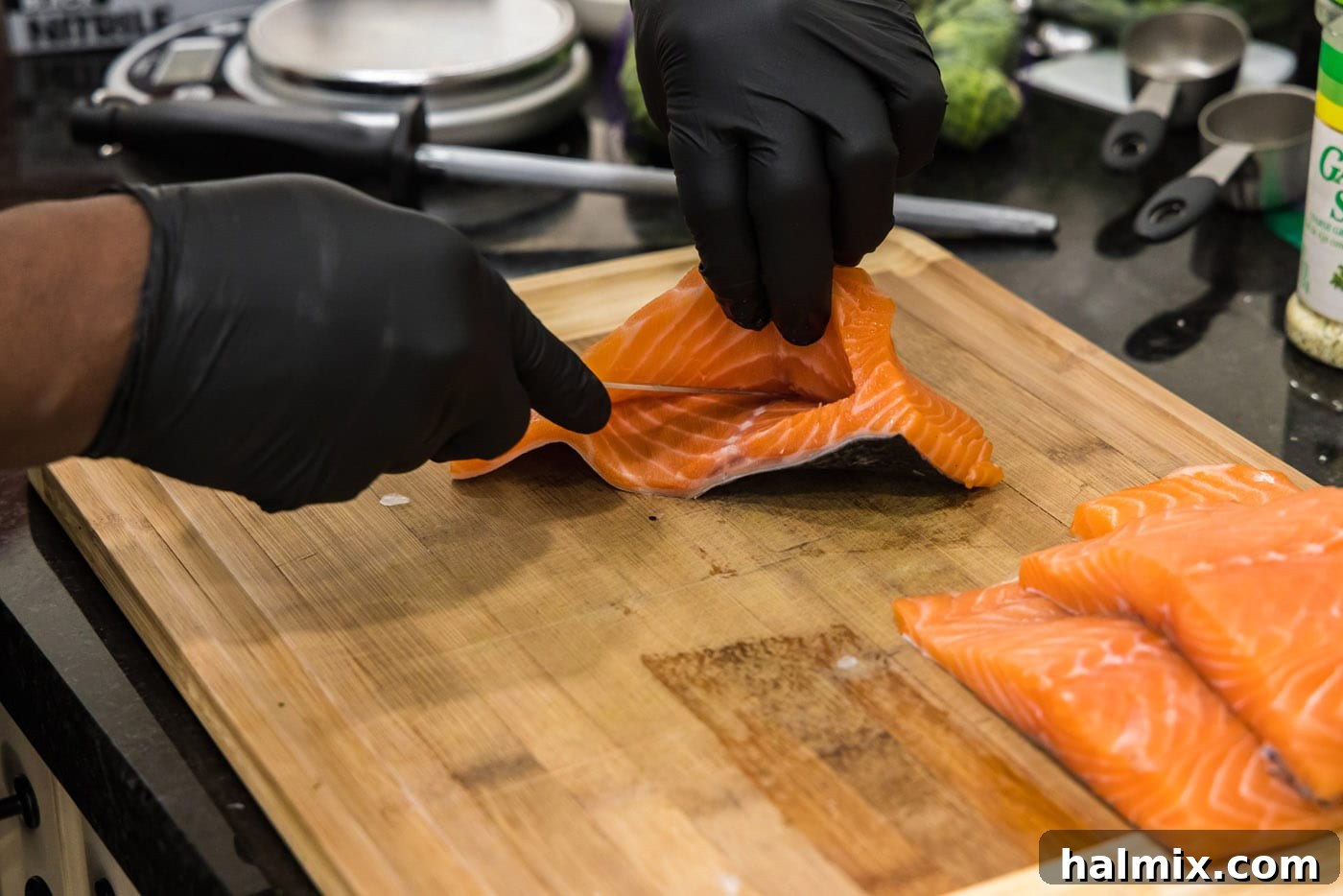Gently opening the pocket sliced into a salmon fillet, making room for the delicious stuffing.