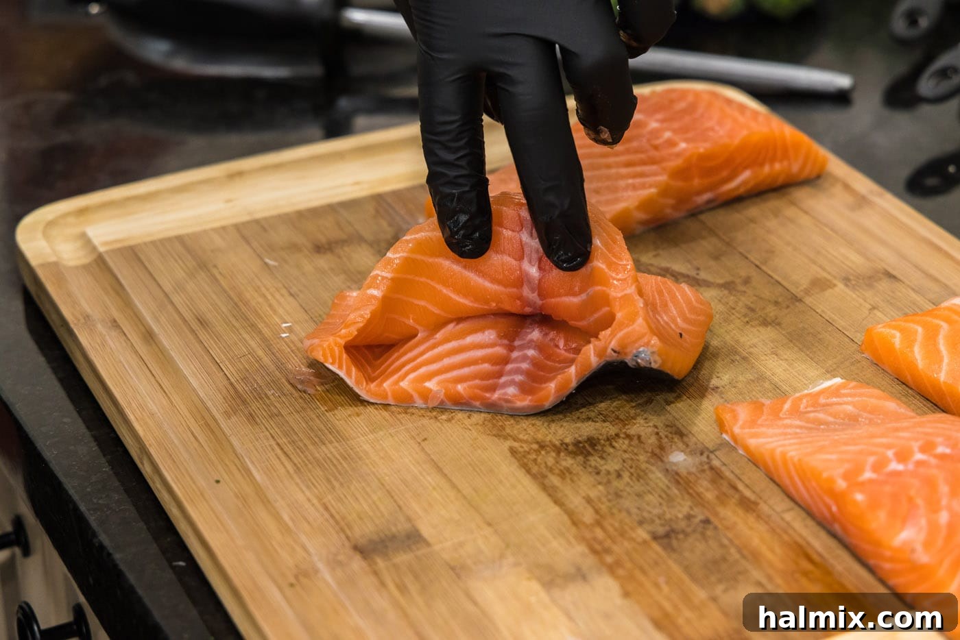 A salmon fillet with a perfectly formed pocket, ready to be filled with the savory stuffing.